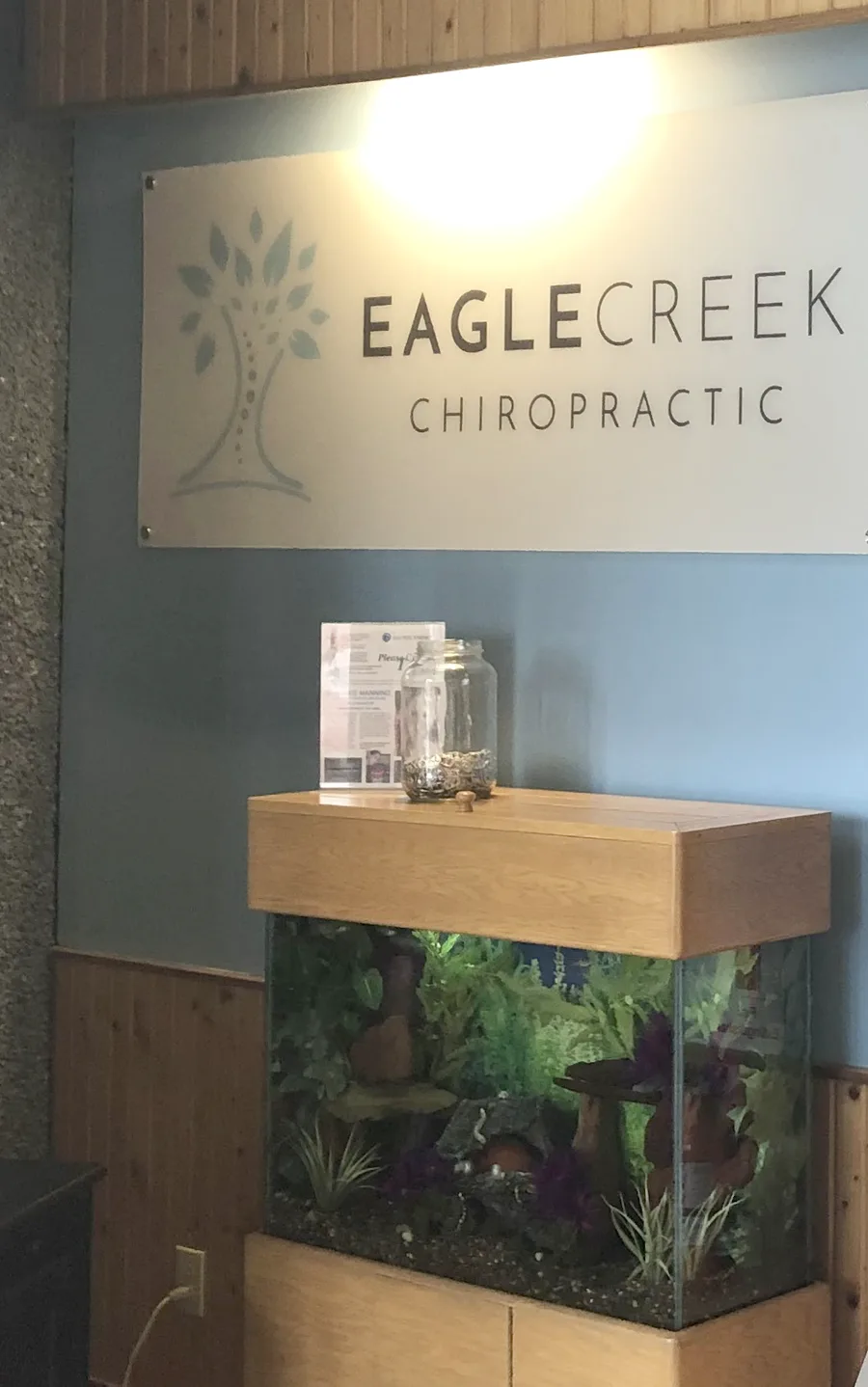 The Eagle Creek Chiropractic sign and aquarium in the reception area.